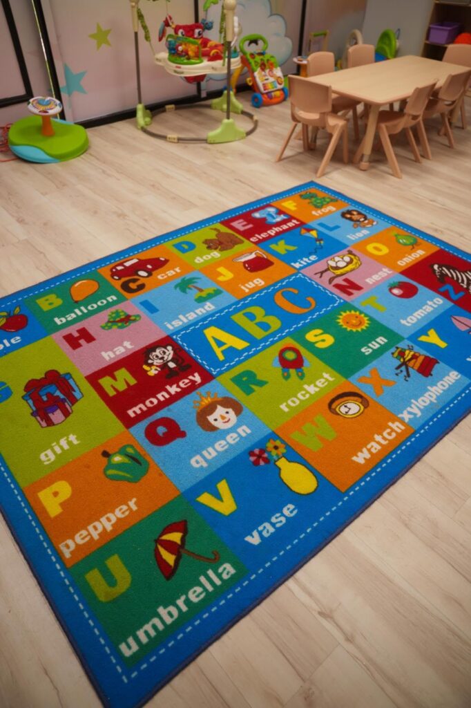 Colorful alphabet learning area with child-sized furniture at Starz R Us