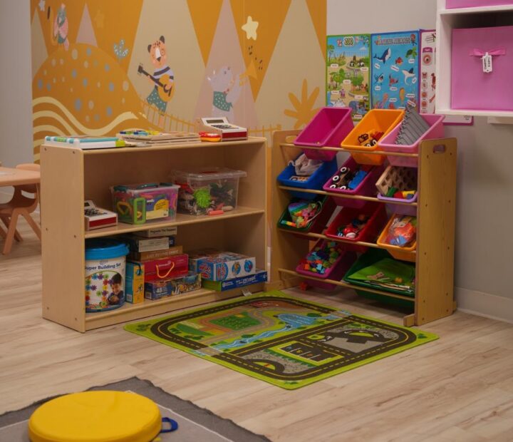 Classroom learning centers with books, puzzles, toys and colorful storage
