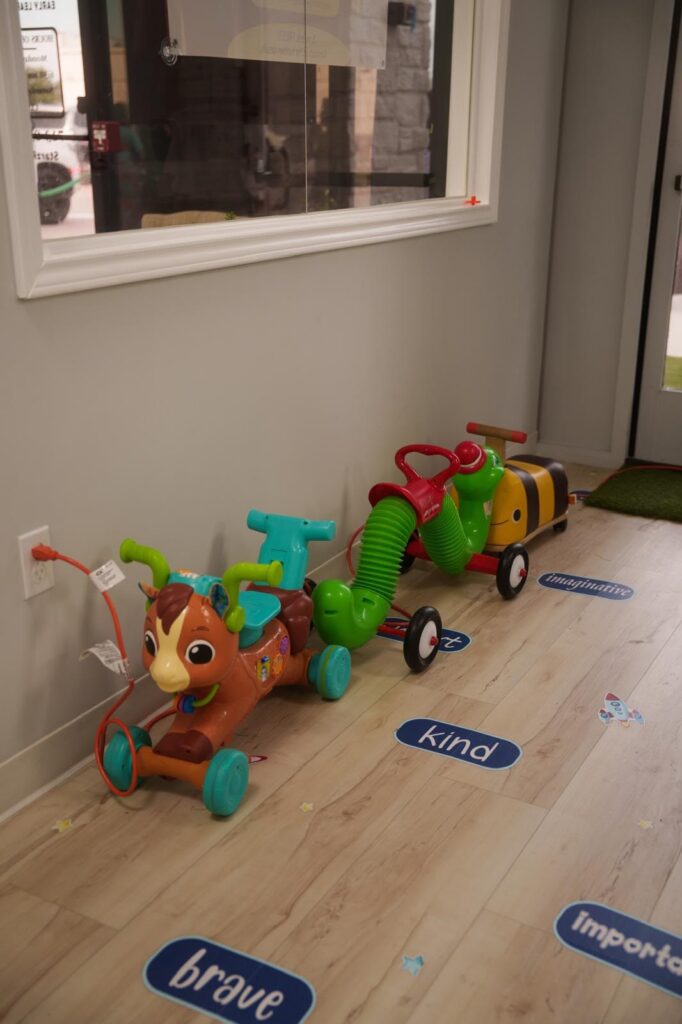 Child-friendly activity area with ride-on toys at Starz R Us